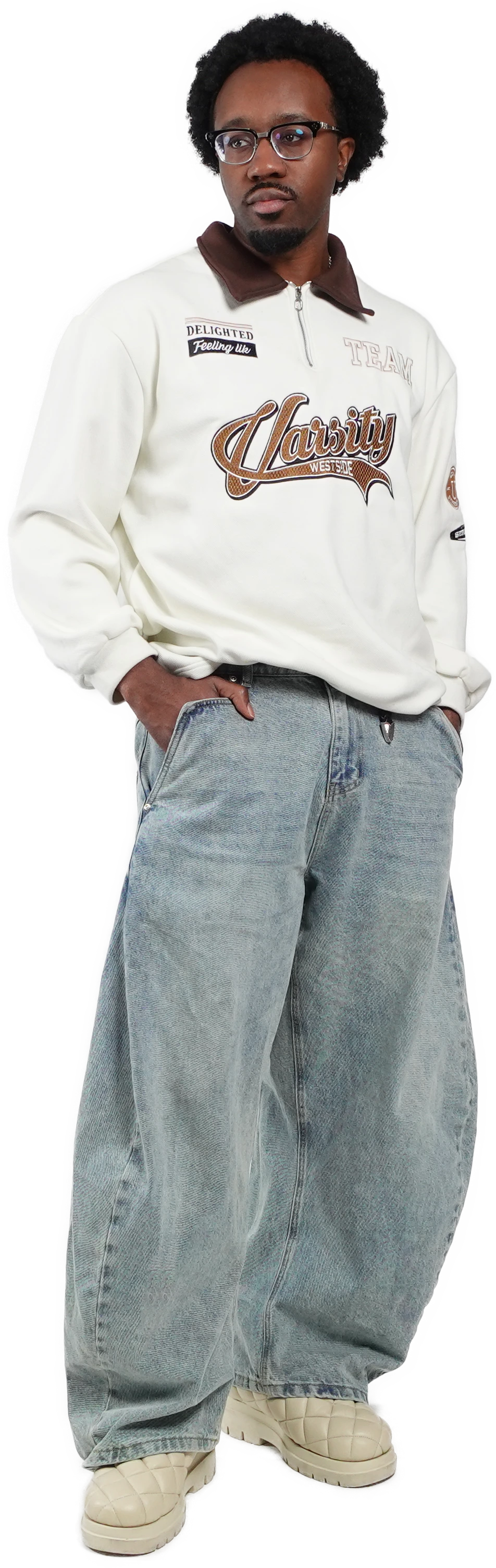 Male model wearing TROPE Labs Curve 1010 light blue barrel jeans with a white varsity sweatshirt
